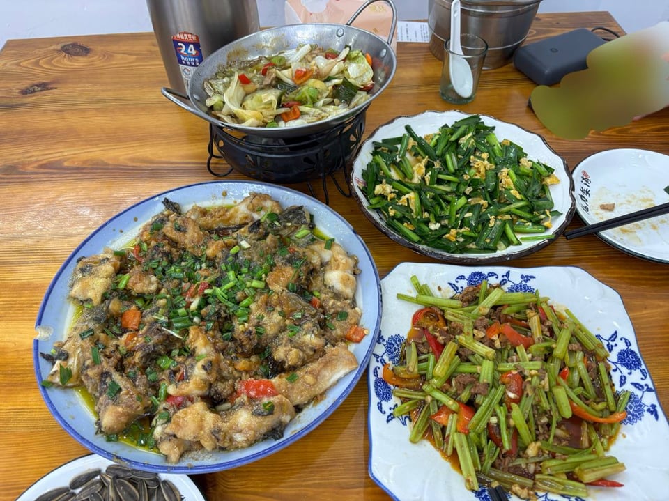 Home-style dishes including braised fish, celery stir-fry, and chives with egg.