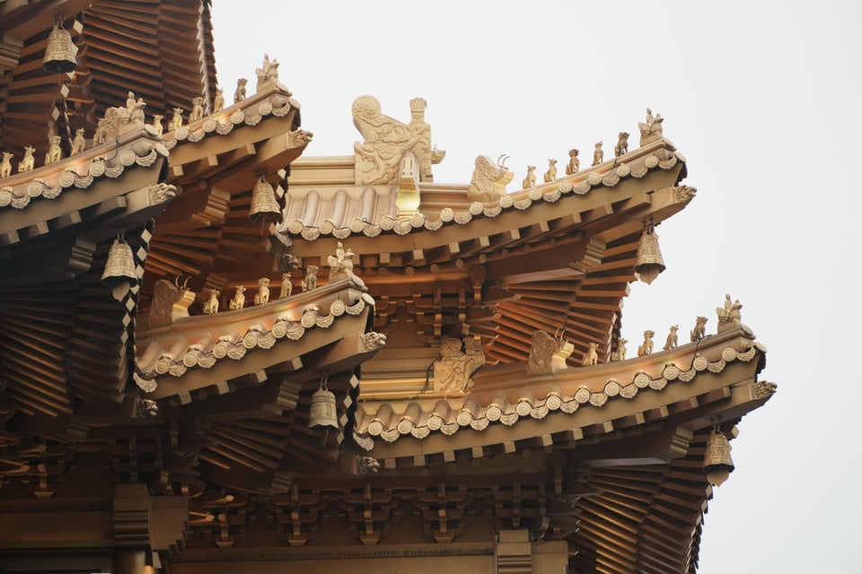 Golden eaves and bells on a summit temple roof.