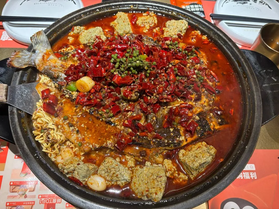 A spicy grilled fish covered in dried chilies and green peppercorns.