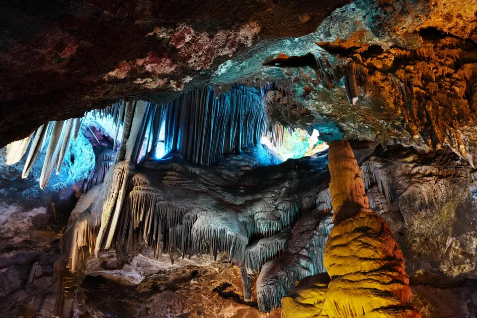 Colorfully lit stalactites inside Jiguan Cave.