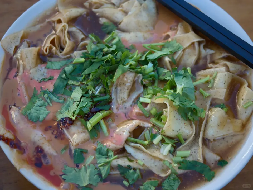Tianjin guobacai topped with chopped cilantro and sauce.