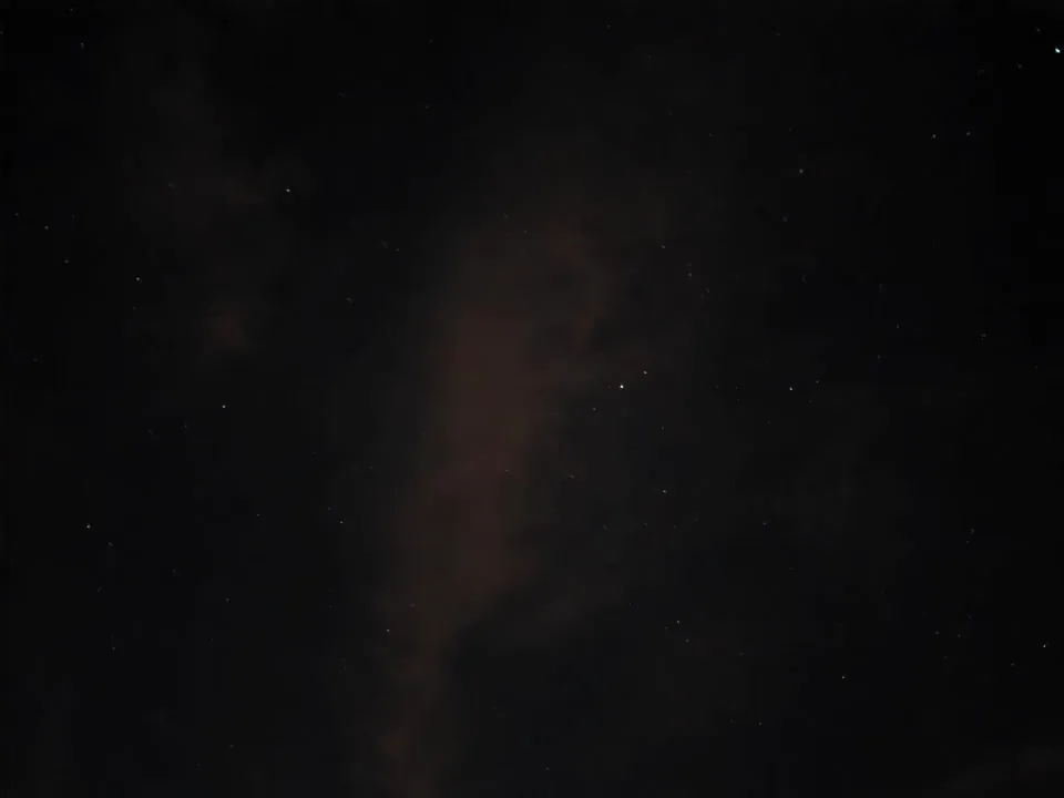 Stars and a faint cloudy band stretching across the night sky.