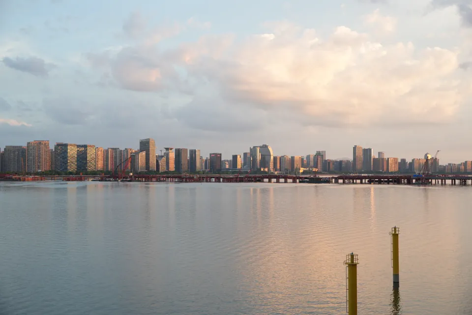 Distant riverside skyline beneath glowing evening clouds
