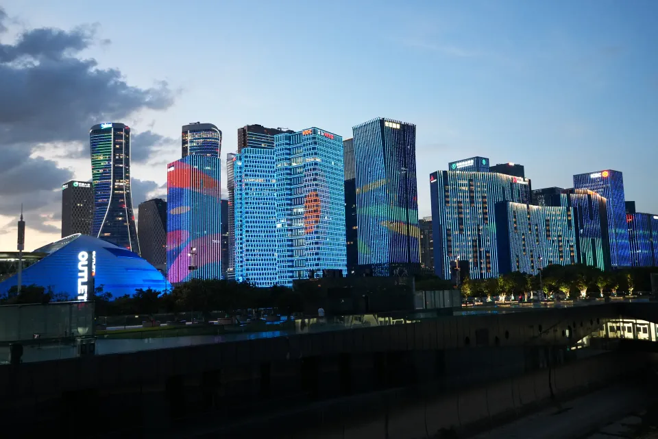Qianjiang New City buildings illuminated in blue at dusk