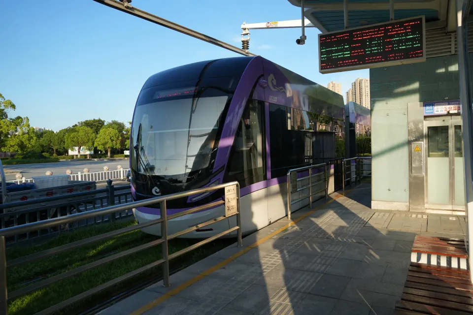Purple tram stopped at an elevated platform in Huaian