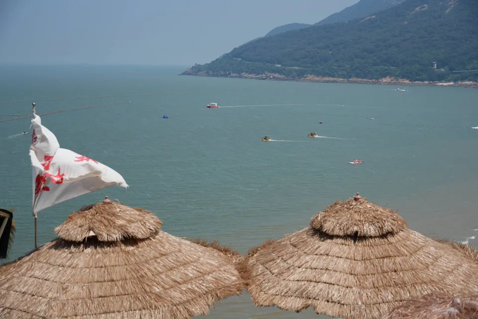 Thatched sunshades overlooking the sea and Liandao coastline