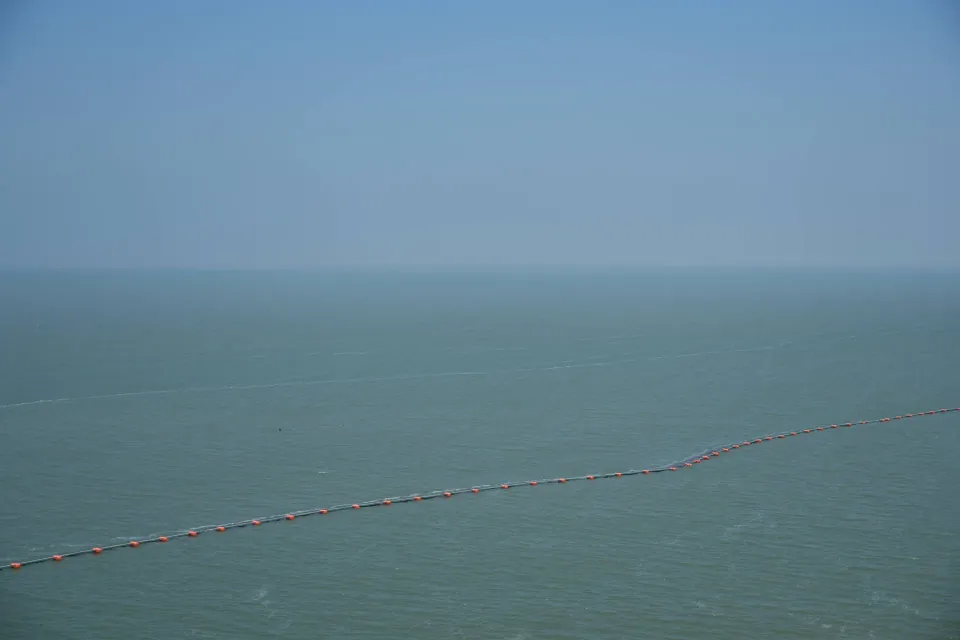 Open sea beyond a floating safety barrier