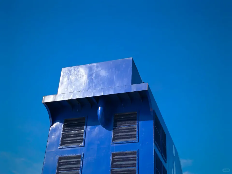 The ferry's blue funnel against the sky.