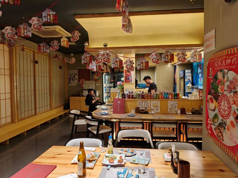 Tables and colorful decorations inside a Japanese restaurant.