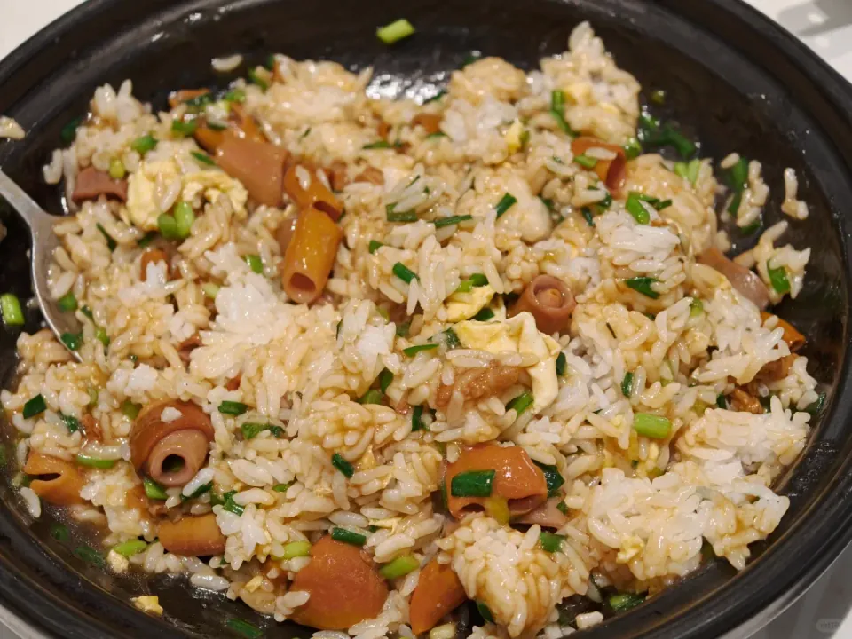 Sea-intestine fried rice with chopped green vegetables.