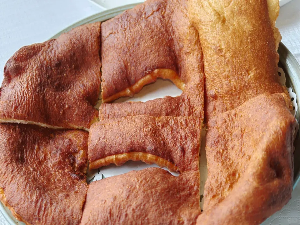 Large sheets of golden-brown flatbread cut into rectangles.